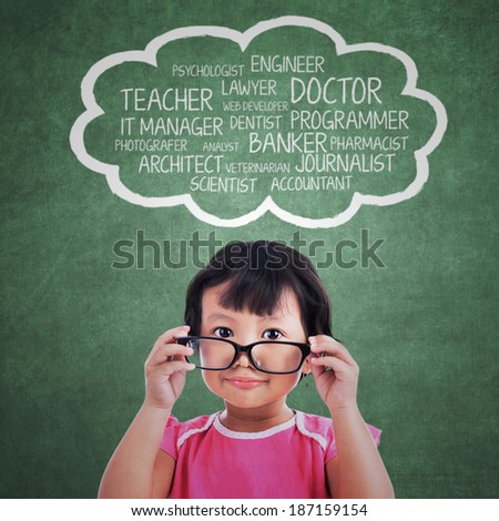 Portrait of cute kindergarten with her ideals over her head