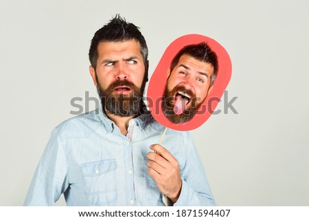Face expression. Emotions. Advertising. Bearded man holds board with face. Feeling and emotions. Face expression. Bearded man with cardboard in hand. Confused man holds board.