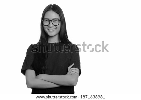 Portrait of happy young beautiful Asian teenage girl smiling with arms crossed