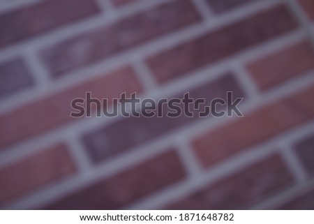 Blurred image of a brown tile floor.