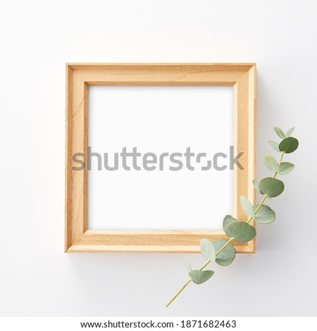 photo frame mock up, eucalyptus leaves and shadows top view, flat lay, copy space.