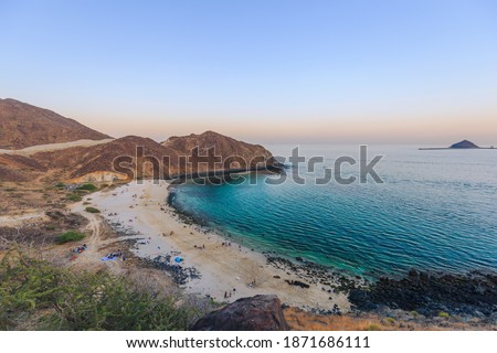 Heart beach in Khor Fakkan, Fujairah, United Arab Emirates covered by mountains on the coastline during sunset Royalty-Free Stock Photo #1871686111