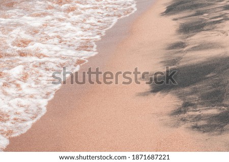 Transparent sea waves on the warm sandy seashore. Sea vacation and travel.