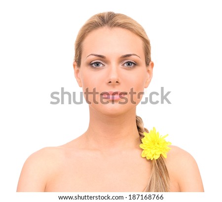 Beautiful young woman with a bright yellow flower in braid on white background close-up