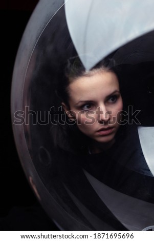 portrait of a woman through the ball, black background