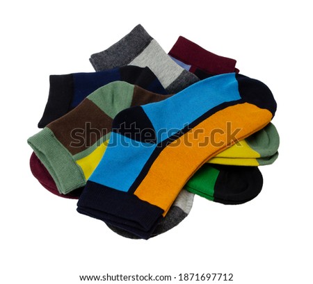 on a white background a lot of multicolored socks are laid out and isolated