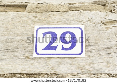 Number twenty-nine in a wall, detail of a number of information in a house, odd number
