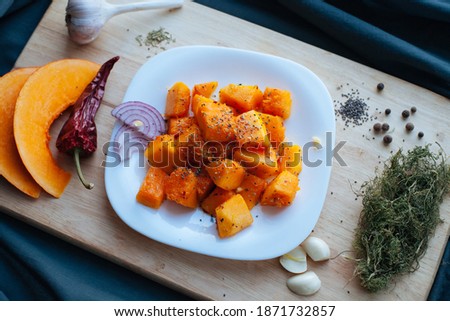 beautiful vegetarian food pumpkin on a white plate with spices