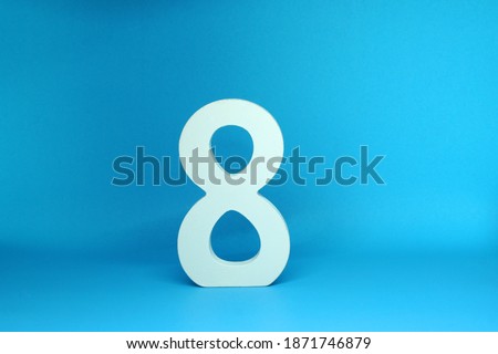 Eight ( 8 ) white number wooden  Isolated Blue Background with Copy Space - Mockup Use for New promotion 8% Percentage  Business finance Concept