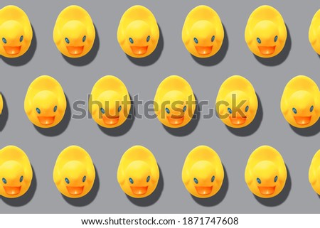 illuminating yellow rubber ducks repeating pattern on ultimate gray  background