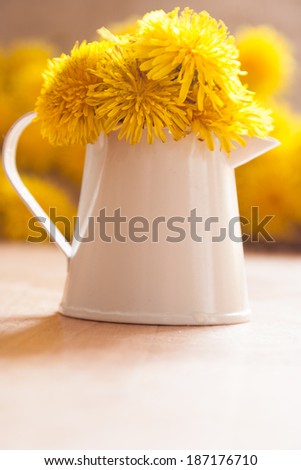 vase with dandelions
