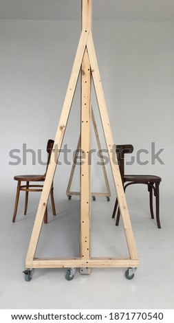A corner of a photo studio with 2 chairs and a white cyclorama. checking the lights before shooting. Copy space.