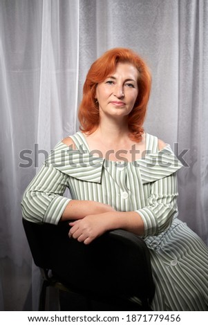 Portrait of Attractive Old woman with beautiful ginger hair