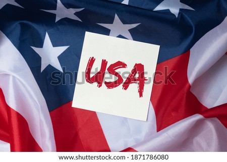 USA inscription acronym on american flag background. United states text