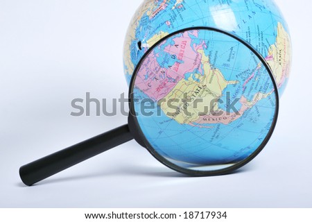 Conceptual image of a magnifying-glass over an world globe