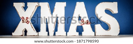 white xmas letters on blue