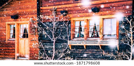 traditional Swiss wooden hut and snowfall