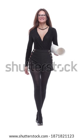 confident young woman with a roll of drawings striding forward.