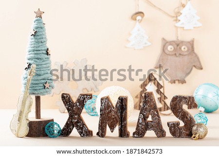 Rustic Christmas background with standing wooden letters spelling Xmas with cristmas tree, copyspace for your greeting card