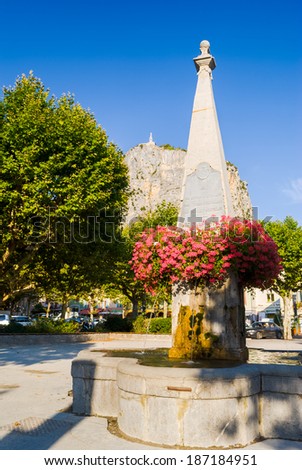 Flowers and fountain in an old French village