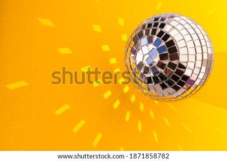 Retro mirror disco ball sun glare reflection copy space. Disco night life party dance 70s 80s concept. festive new year christmas xmas. abstract yellow minimal background, banner, frame, card