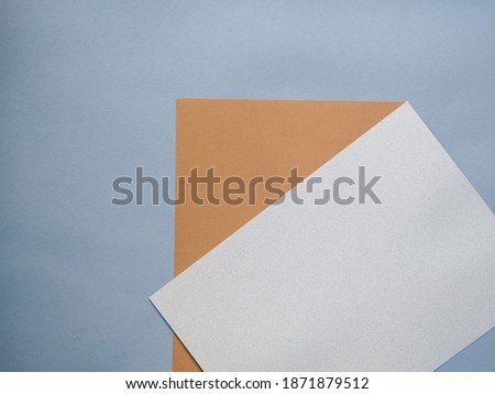 flat sheets of pink brown and gray paper. top view. copy space. flat lay. 