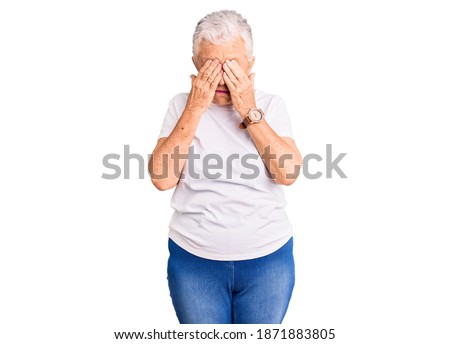 Senior beautiful woman with blue eyes and grey hair wearing casual white tshirt rubbing eyes for fatigue and headache, sleepy and tired expression. vision problem 