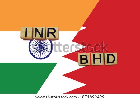 India and Bahrain currencies codes on national flags background. International money transfer concept