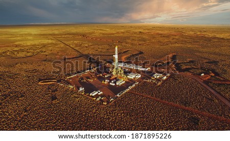 Aerial photo of hydraulic fracturing equipment at sunset. (FRACKING) Royalty-Free Stock Photo #1871895226