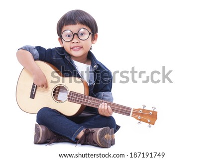 Cute boy playing the ukulele on white background 