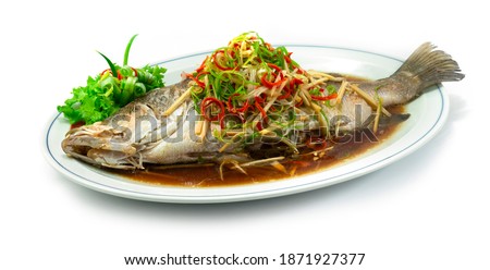 Steamed Sea bass Snapper Fish with Soy Sauce Chinese food style sideview Royalty-Free Stock Photo #1871927377