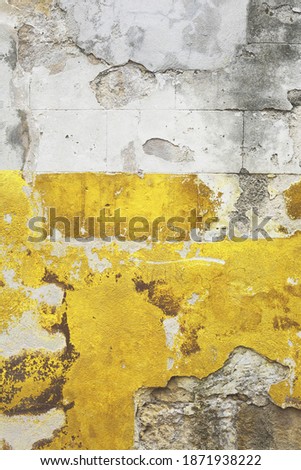 Rough illuminating yellow and ultimate grey background. Textured old building wall with cracks. Retro grunge abstract aged surface. Copy space for message. 2021 trendy colors