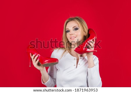 Shoes sale. Happy woman holds shoes. Shopping. Beauty and fashion. Advertising. Discount and sale.