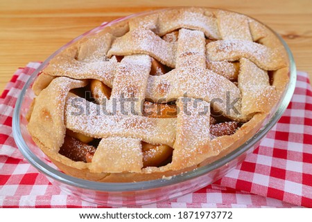 Delectable fresh baked homemade tasty and healthy apple pie on checker kitchen cloth