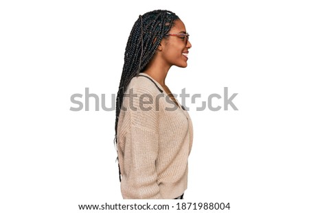 African american woman wearing casual clothes looking to side, relax profile pose with natural face and confident smile. 