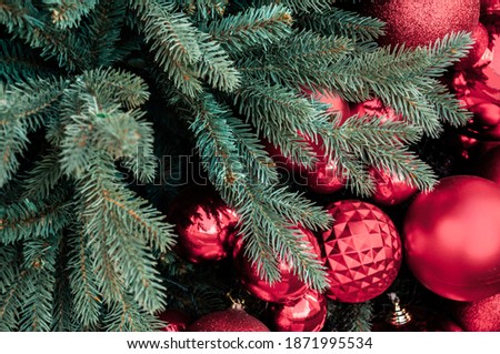 Red Christmas ball on Christmas tree. Selective focus red Christmas ball hanging on Christmas tree for celebrate. New year decorations.