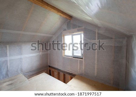 The walls of the frame house are sheathed with a vapor barrier membrane Royalty-Free Stock Photo #1871997517