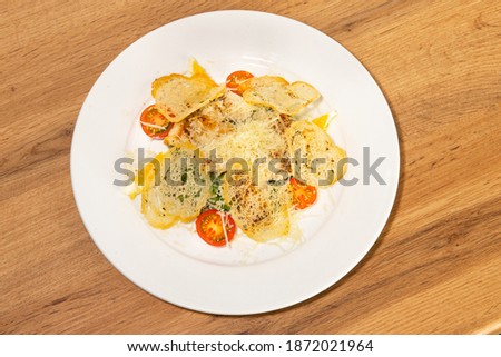 Mini tomatoes, cheese, crackers on a white plate