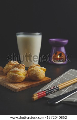 Selective focus of cream puff and milk on the table