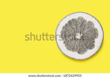 Sliced grapefruit isolated on illuminating with copy space. Creative photo in trends colors 2021: Ultimate Gray and illuminating