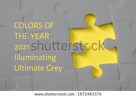 Multiple grey puzzle pieces put together without one piece on yellow background. Colors of year 2021. Place for text.