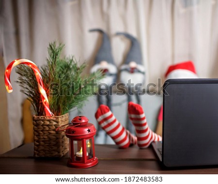 Family Christmas night. Pretty girl sitting on couch and watching movie by laptop at home, family entertainment, festive decoration, childhood and entertainment, indoor lifestyle