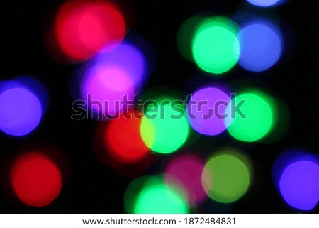 Colorful Bright Abstract Background Design with Blurred Bokeh Red Green Blue Purple Lights. Suitable for Festive Holiday Christmas and New Year Menu, Poster or Flier Adverts.