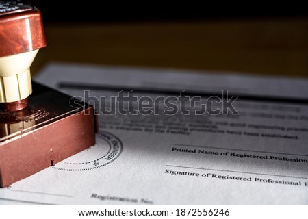 Selective focus on generic professional engineer, architecture. or surveyor stamp and certification statement