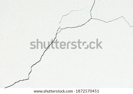 Image for use as a background, diagonally cracked white wall, which is still a small line, not very large. Which the renovation is still easy Royalty-Free Stock Photo #1872570451