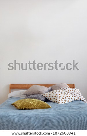 Interior modern lamp and comfortable bed with pillows in cozy bedroom