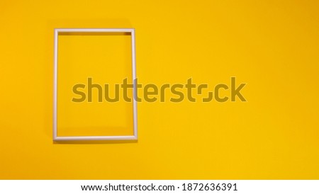 gray frame on yellow background, trending color