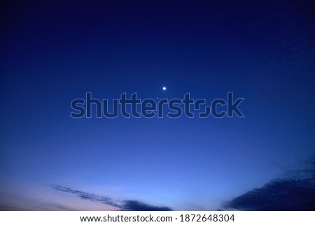 Astronomical conjunction of Venus and Moon, photographed with long focal lens.