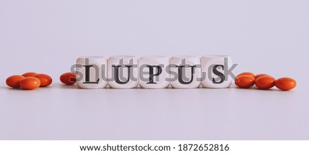 top view blocks with word LUPUS on the white background with pills