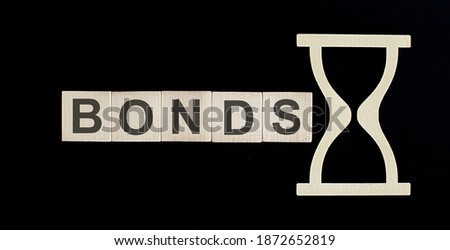 BONDS word from wooden blocks on black background